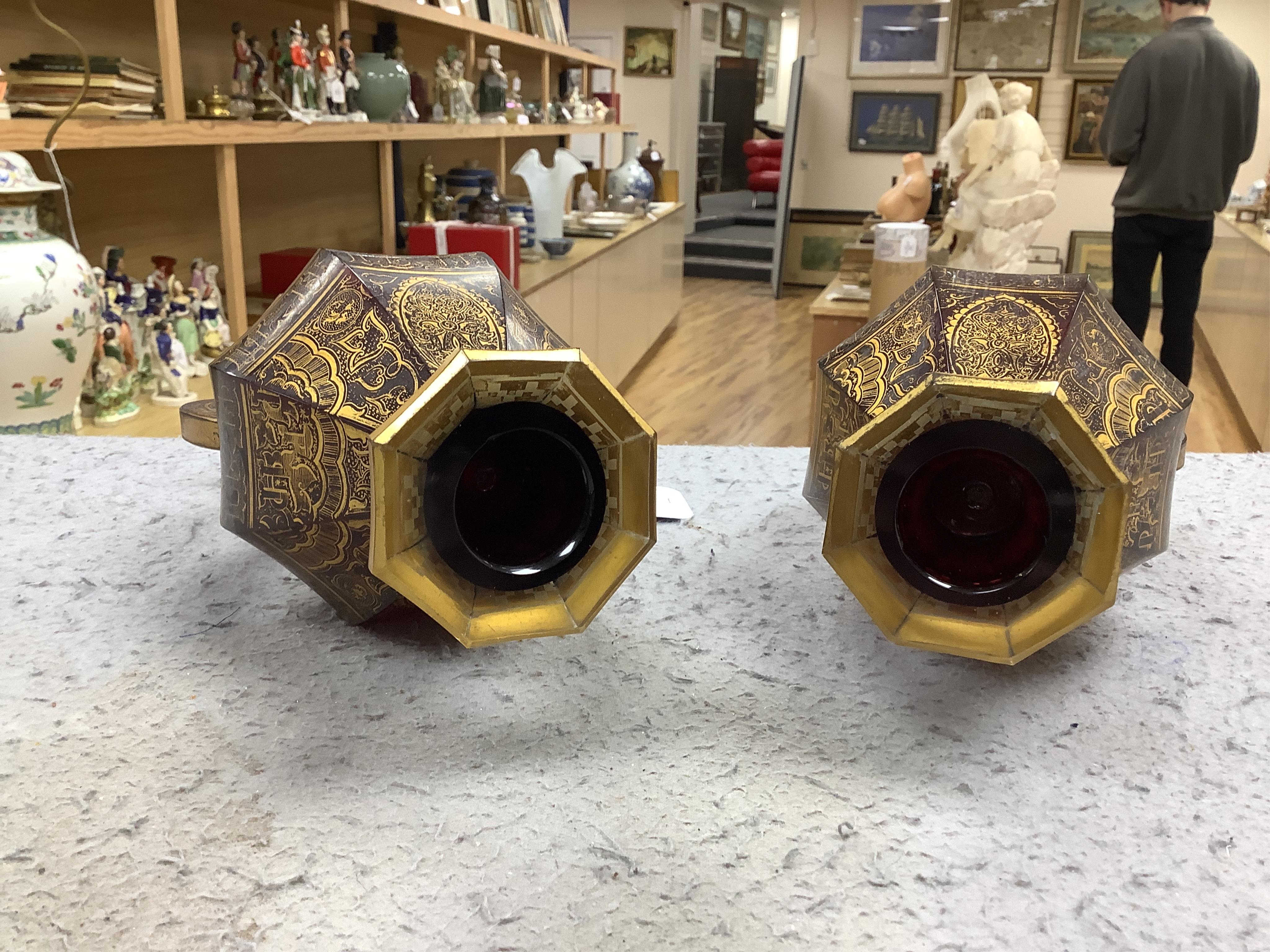 A pair of Venetian Islamic inspired gilt decorated ruby glass twin handled vases, 24cm high. Condition - wear to gilding on both vases